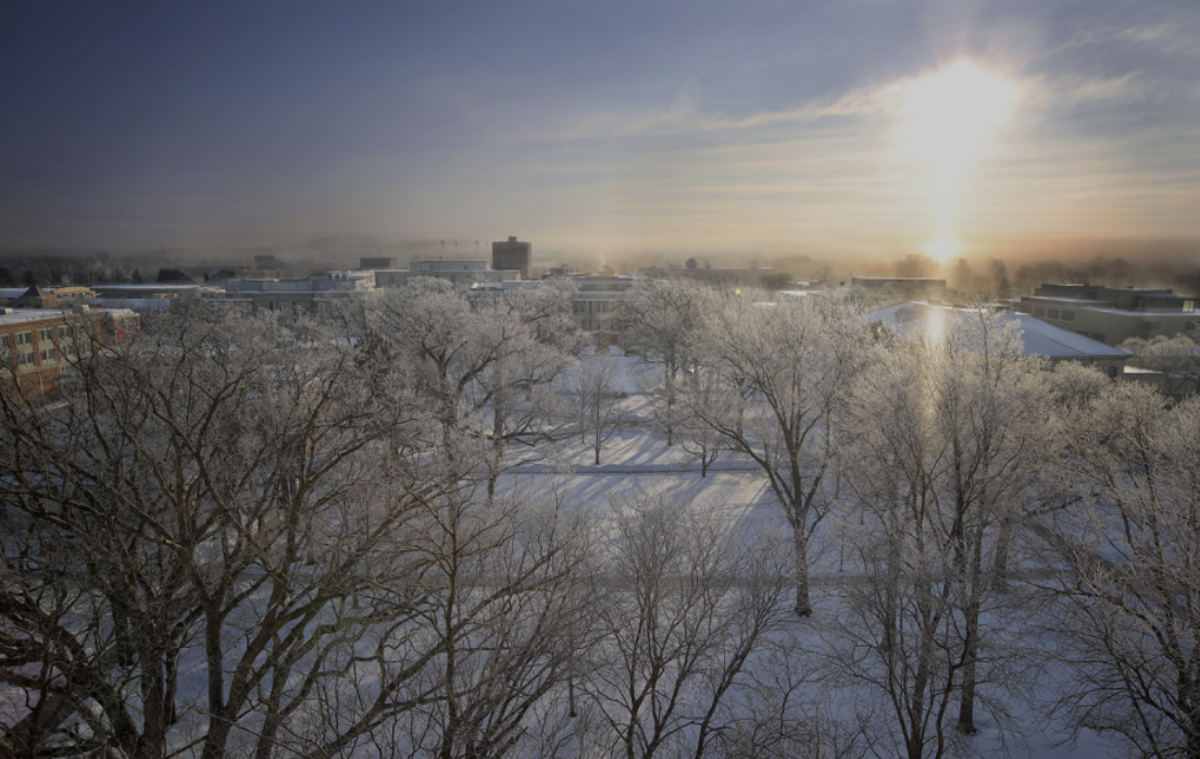 Snowy days are ahead for BG as the sun rises (photo via the official BGSU website).